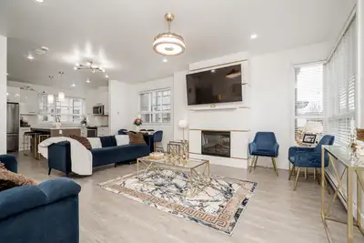 Beautiful 3-bedroom + den end-unit townhome offering rare, unobstructed green space views from the l...