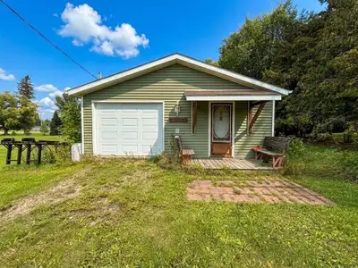 R02//Libau/Compact living with room for your hobbies! Situated on 0.55 acres, this unique one-room h...