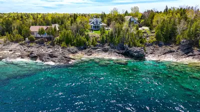 Welcome to your dream waterfront property in the heart of Tobermory. Enter the long winding driveway...