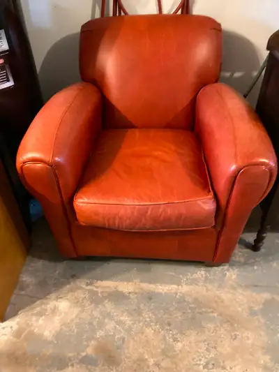 Burnt orange colour. Good chair but has light scratch marks. Comfortable.