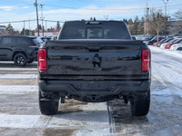 The 2026 Ram 1500 RHO Crew Cab in Diamond Black Crystal Pearl delivers bold styling and high-perform... (image 4)