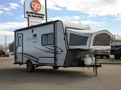 The 2014 Jayco Jay Feather 16XRB is a lightweight hybrid travel trailer that combines hard-sided con...
