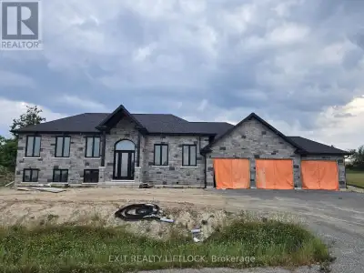 Currently Under Construction- Custom built executive stone bungalow by Davenport Homes in the rollin...