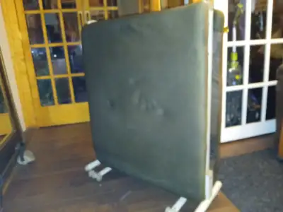 Dark brown folding 33" bed. Would need a mattress for extra comfort. Could deliver for a small fee w...