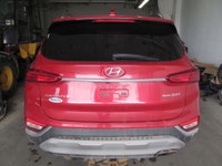 Finished in red with a black interior, this used 2019 Hyundai Santa Fe Preferred delivers the space,... (image 2)