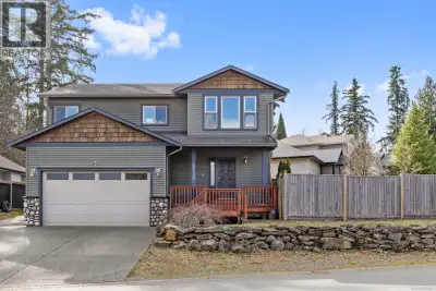 Custom built home with a legal one bedroom suite, ideally located in the vibrant Village of Cumberla...