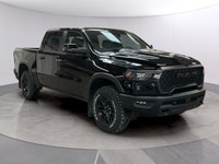 The 2026 Ram 1500 Rebel 4x4 Crew Cab in a striking black hue offers a commanding presence on any ter... (image 6)