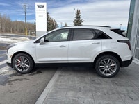 The 2026 Cadillac XT5 Sport AWD, finished in Crystal White Tricoat with a rich Kona Brown interior w... (image 4)