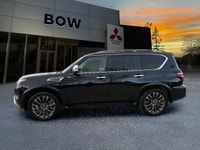 The 2023 Nissan Armada 4x4 Platinum in a striking black finish is a powerhouse SUV designed for both... (image 6)
