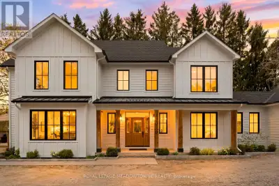 Custom-built country home set on 2.86 acres, offering timeless curb appeal with crisp white siding,...