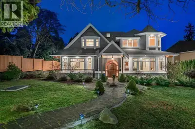 The main level features rich hardwood flooring and refined millwork. The kitchen offers premium stai...