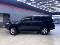 Experience the rugged elegance of the 2016 Toyota 4Runner SR5, presented in a commanding Black finis... (image 1)