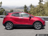 The 2020 Buick Encore Essence, dazzling in Winterberry Red Metallic with a sophisticated Ebony leath... (image 5)