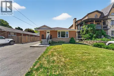 Welcome to this charming detached bungalow with fully separate in-law suite offering the perfect ble...
