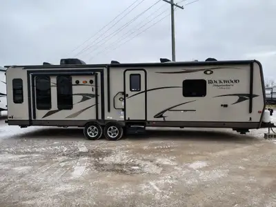 The 2013 Rockwood 8329SS is a three-slide-out travel trailer from the Signature Ultra Lite series, f...
