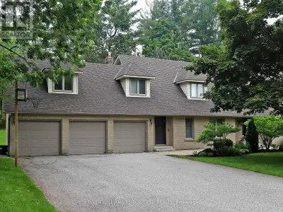 Own your own slice of paradise on 1.15 acres in the prestigious estate community of Woodland Acres!...