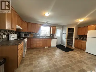 Seize this exceptional investment or family-living opportunity! This spacious 1/2 duplex bi-level of...