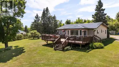 Tucked away on a beautiful 1 acre lot just steps from Head Lake. this charming country bungalow offe...