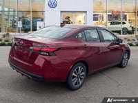 Designed for efficiency and confident urban navigation, this vibrant red 2024 Nissan Versa SV, is yo... (image 3)