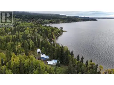 This stunning 2.28-acre lakefront property boasts 202 ft of shoreline with a boat launch & water rig...