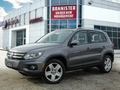 The 2012 Volkswagen Tiguan Highline in its sophisticated gray hue, paired with an agile AWD drivetra...