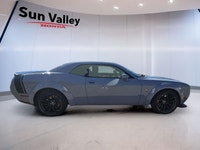 The 2022 Dodge Challenger Scat Pack boasts a roaring 392 Hemi engine paired with a manual transmissi... (image 1)
