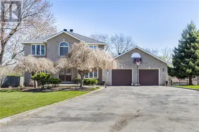 Located on a stunning 1.8-acre lot backing onto peaceful green space, this impressive all-brick two-...