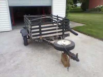 Small trailer with removable side racks. Deck is 73 inches long by 52 inches wide . Has been stored...