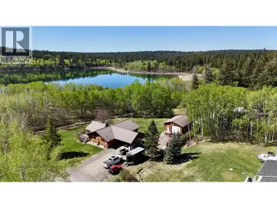 Charming 4 bedroom, 2 bathroom log home set on a spacious lot backing directly onto the 108 Mile Lak...