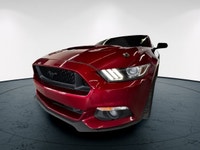 The 2016 Ford Mustang GT in vibrant red with a rear-wheel-drive setup promises dynamic handling and... (image 4)