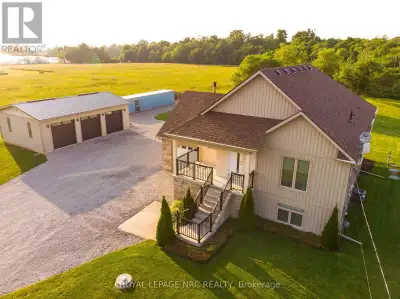 You will love this custom-built raised bungalow on a private 1-acre lot, complete with a massive 36'...