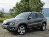 The 2012 Volkswagen Tiguan Highline in its sophisticated gray hue, paired with an agile AWD drivetra... (image 1)