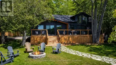 Experience the pinnacle of turnkey lakeside living in a sheltered bay on the crystal-clear waters of...
