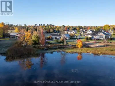 This custom built brick bungalow is situated on stunning Ottawa River waterfront that will keep you...
