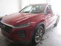 Finished in red with a black interior, this used 2019 Hyundai Santa Fe Preferred delivers the space,... (image 1)
