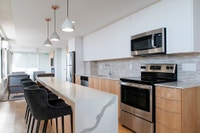 **Upgraded suites available which include high gloss white cabinetry and quartz countertops. In-suit... (image 4)