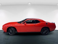 Meet the 2022 Dodge Challenger GT in a vibrant orange finish, gracefully combined with an AWD drivet... (image 1)