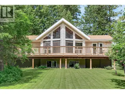 This Jaffray home on a private 1-acre parcel with mature trees, nature all around, and recreation in...