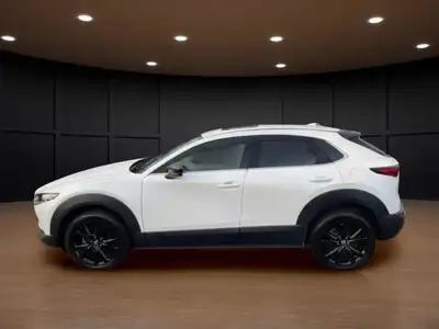 The 2022 Mazda CX-30 GT w/Turbo AWD in stunning white exudes confidence and offers a smooth handling...