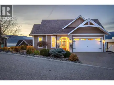 Set on the shimmering shores of Okanagan Lake, this immaculate 5-bedroom, 4.5-bath home defines Luxu...