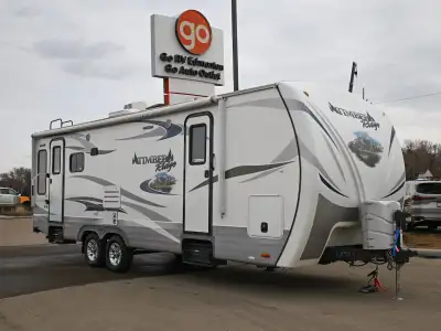 The 2014 Timber Ridge 26RLS is a durable rear-living travel trailer designed for comfort and extende...