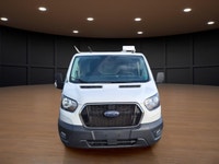 The 2023 Ford Transit Cargo Van, clad in a clean white finish and equipped with rear-wheel drive, of... (image 1)