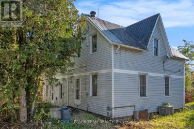 Just East of Metcalfe a rural opportunity on five private acres! 1870's farm home seeking new owners...