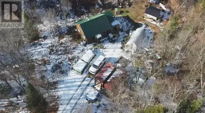 Discover true wilderness living on this private 25-acre off-grid property, featuring a cozy rustic c...