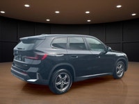 Experience the luxury of driving a black 2023 BMW X1 xDrive28i Sports Activity Vehicle with its comp... (image 4)