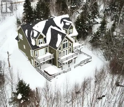 Welcome to 52 Lake View Drive. Settled on a 1 acre lot, this 6 bedroom, 5 and 1/2 bathroom chalet is...