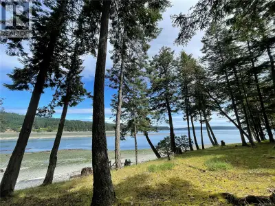 Let the seabreeze & sounds of waves lapping on the shore be yours to enjoy from your own .74 acre wa...