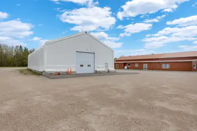 High quality 8060 coverall building with large commercial bay doors, asphalt floor, power, and brigh...