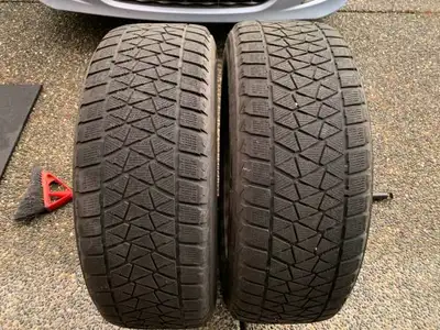 up for sale is a nice pair of 18 inch black steel rims mounted with Bridgestone winter tires size 23...