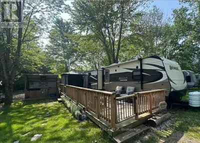 Your Ideal Summer Getaway Awaits! Escape to nature with this spacious, well-treed lot featuring a un...
